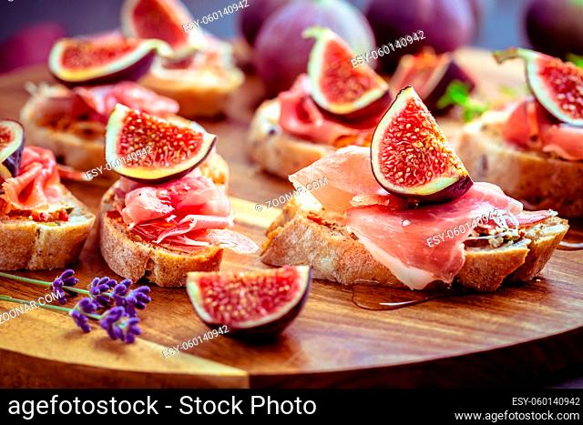 Small open sandwiches with ciabatta, proscuitto and fresh figs as appetizes