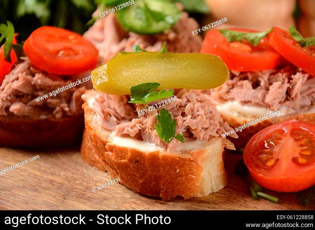Open sandwich with canned tuna, cucumber, tomatoes, pickled cucumber