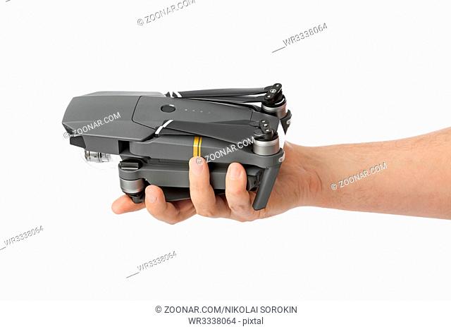 Folded drone in hand - isolated on white background