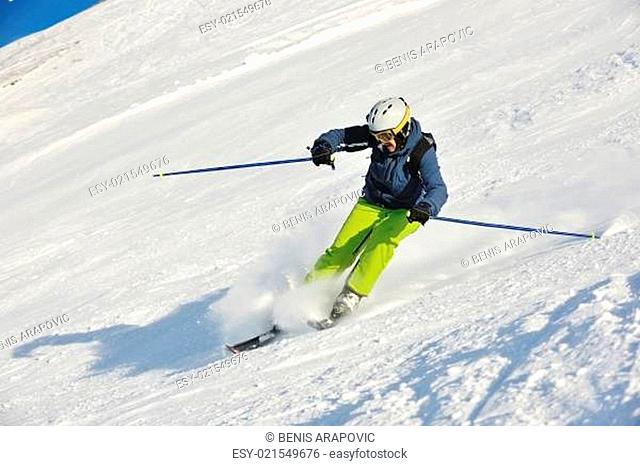skiing on fresh snow at winter season at beautiful sunny day