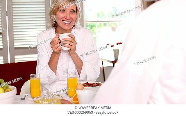 Happy couple having breakfast together