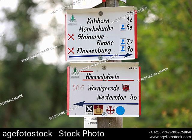 13 July 2023, Saxony-Anhalt, Wernigerode: View of a hiking signpost with the inscription Himmelpforte. The Augustinian monastery Himmelpforte - also called...