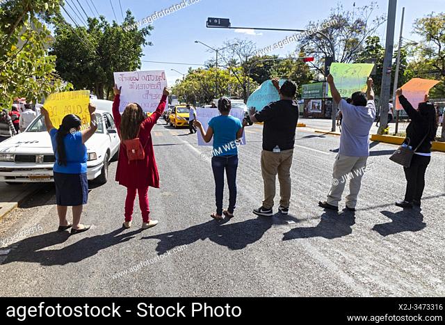 Oaxaca, Mexico - The social security workers union stages a protest by holding up signs on a major street outside the Mexican Institute of Social Security's...