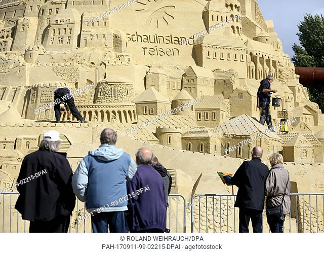 The tallest sand castle in the world is being repaired with the help of a cherry picker at the Landschaftspark in Duisburg, Germany, 11 September 2017