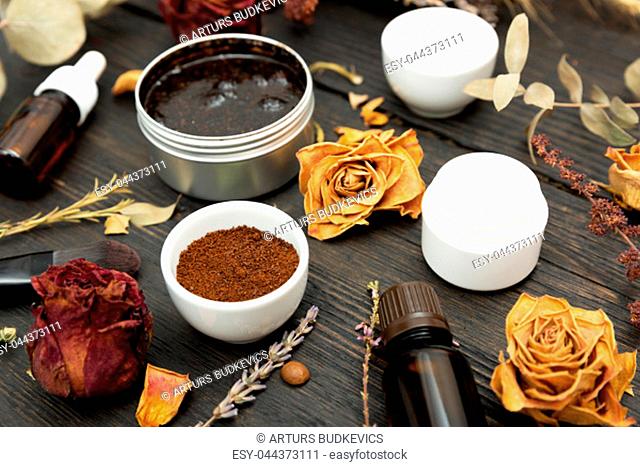 Aromatic botanical cosmetics. Dried herbs flowers mixture, aromatic homemade scrub paste made from coffee grounds and oils