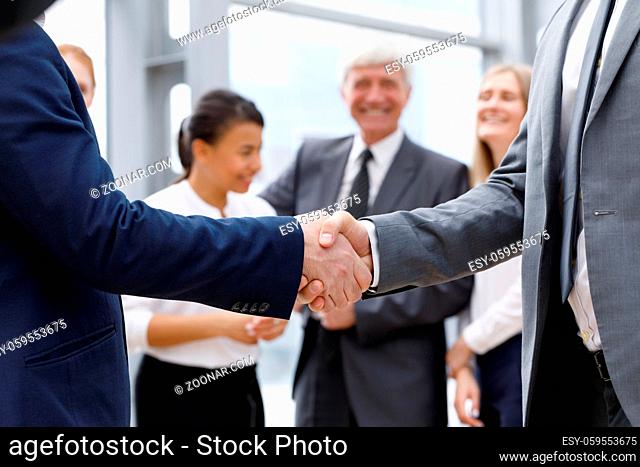 Handshake of business people in the lobby of an office building