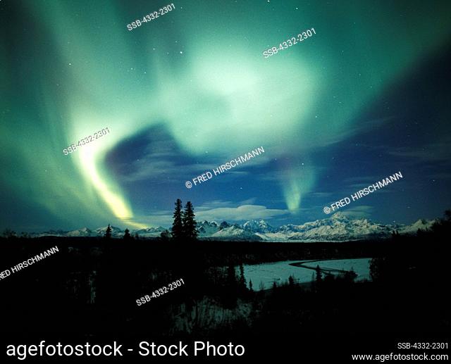 Beautiful display of northern lights over the Alaska Range including Mount McKinley or Denali with the Chulitna River in the foreground, Denali State Park