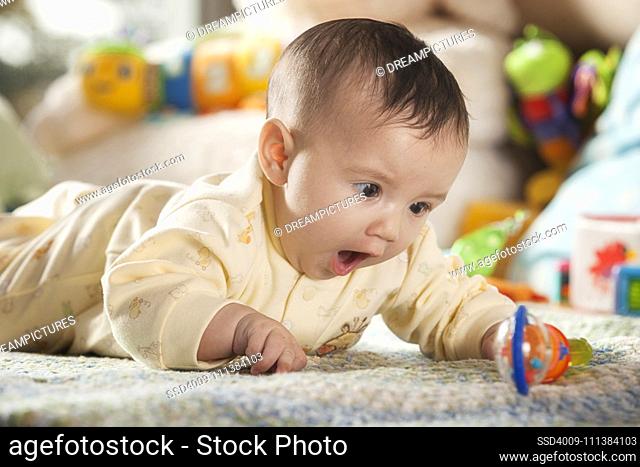 Hispanic baby playing with toys