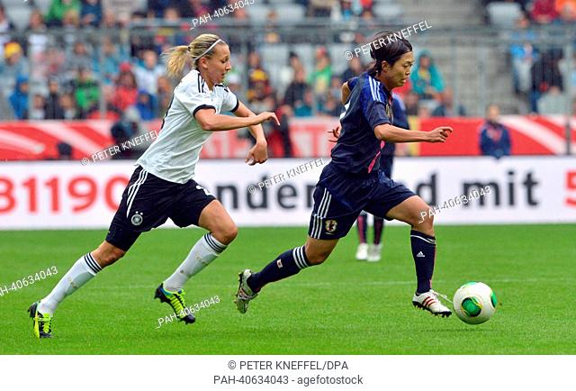 Germany's Lena Goessling (L) vies for the ball with Japan's Kozue Ando during the Women's international friendly football match Germany vs Japan at Allianz...