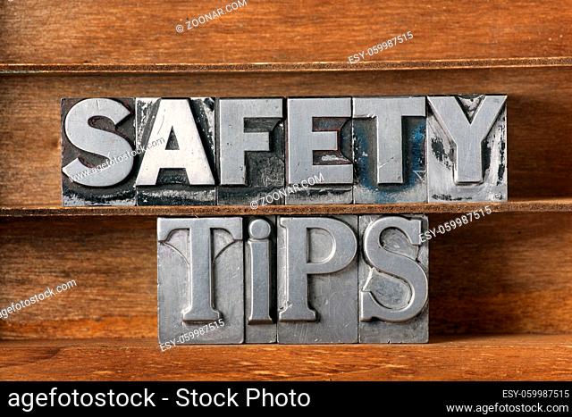 safety tips phrase made from metallic letterpress type on wooden tray
