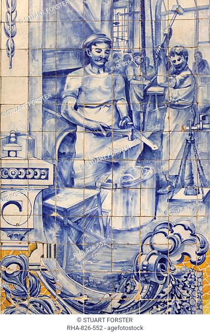 A blacksmith's workshop depicted on traditional Portuguese Azulejo tiles on a building in Alfama, Lisbon, Portugal, Europe