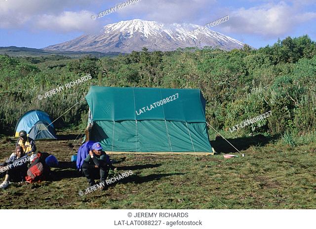 Rongai route. 2600 metres. Camp site. Tent. Three people. Kibo volcanic cone. Snow, ice cap