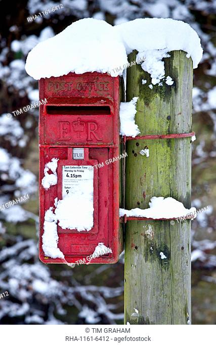 Postbox in snow scene in The Cotswolds, Swinbrook, Oxfordshire, United Kingdom