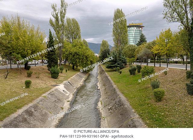 28 October 2018, Albania, Tirana: Raiffeisen Bank International AG (r.) in the centre of Tirana and on the river Lana (Lanë)