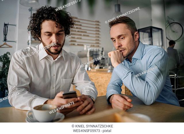 Two businessmen having a meeting in a coffee shop