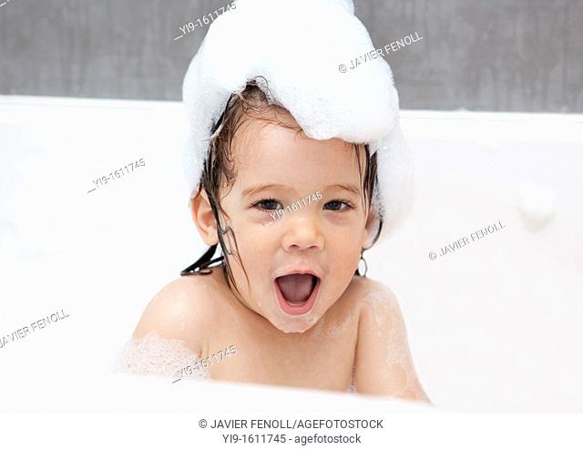 child taking a bubble bath