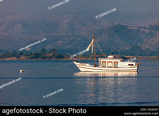 Beautiful boat on Lake Pichola on the background of mountains
