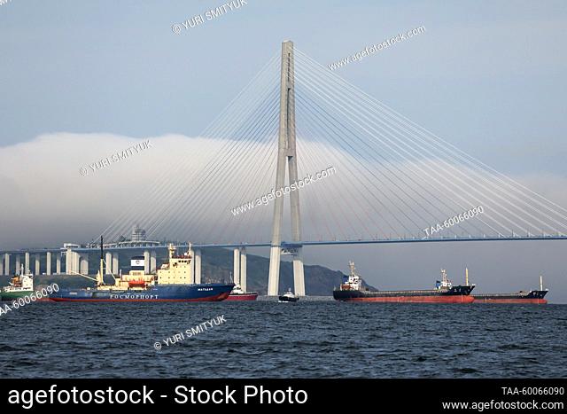 RUSSIA, VLADIVOSTOK - JUNE 24, 2023: Ships pass under Russky Bridge in Eastern Bosporus Strait. Yuri Smityuk/TASS