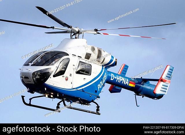 07 December 2022, Lower Saxony, Hooksiel: A Lower Saxony police helicopter lands on land after flying over the LNG terminal under construction and the...