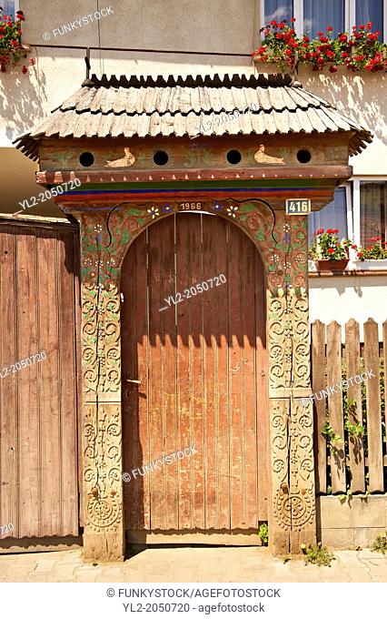 Traditional wooden Szekely gates in a Szekely village near Cluj, Eastern Transylvania. Carved with folk art & painted the Szekely gate also has dove cotes above...