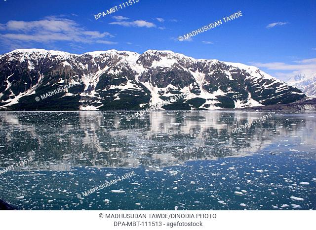Icebergs with Hubbard glacier and saint Elias mountain ;  The longest tidewater glacier in Alaska ; Saint Elias  national park ; Disenchantment bay ; Alaska ; U
