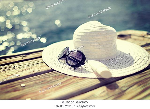 beach, summer, vacations and accessories concept - close up of beach accessories at seaside