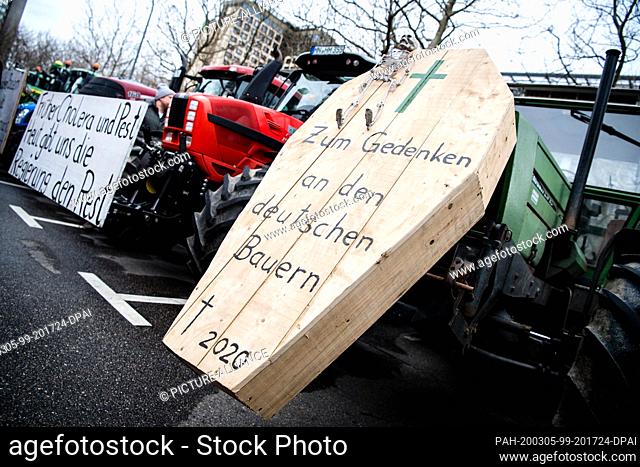 05 March 2020, Bavaria, Munich: A coffin with the inscription ""In memory of the German farmer - died 2020"" and a sign with the inscription ""Early cholera and...