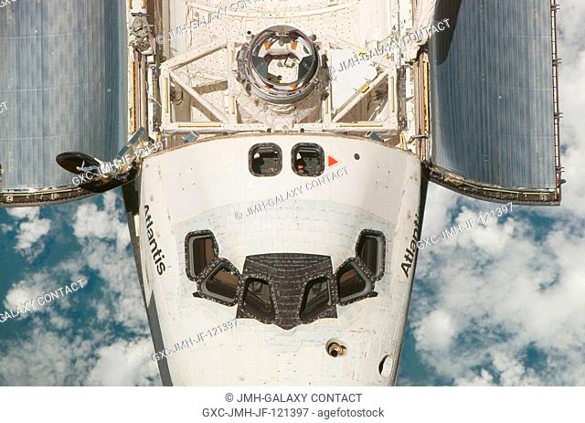 An overhead view of the exterior of the Space Shuttle Atlantis' crew cabin, part of its payload bay doors and docking system was provided by Expedition 16...