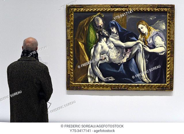 Visitor looks at a painting of El Greco at the exhibition at the Grand Palais in Paris