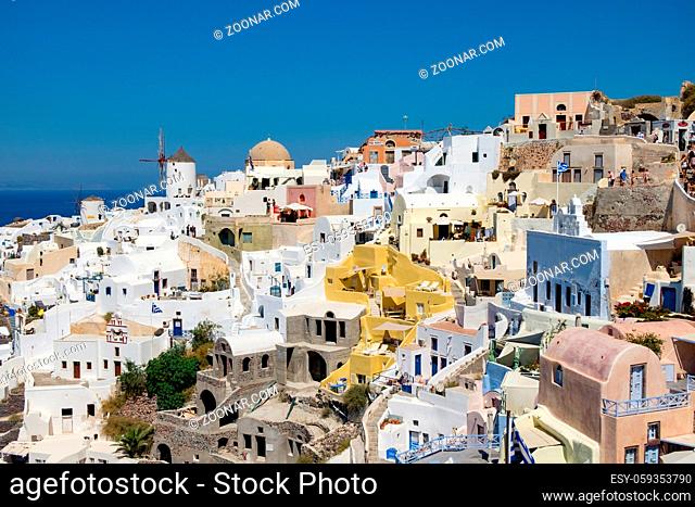 Beautiful view with traditional white buildings over the village of Oia at the Island Santorini, Greece