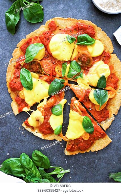 Chickpea, tomato, cheese and basil pizza