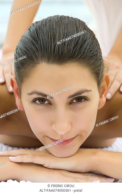 Young woman enjoying massage, cropped