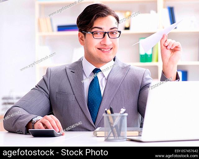 The businessman with paper airplane in office