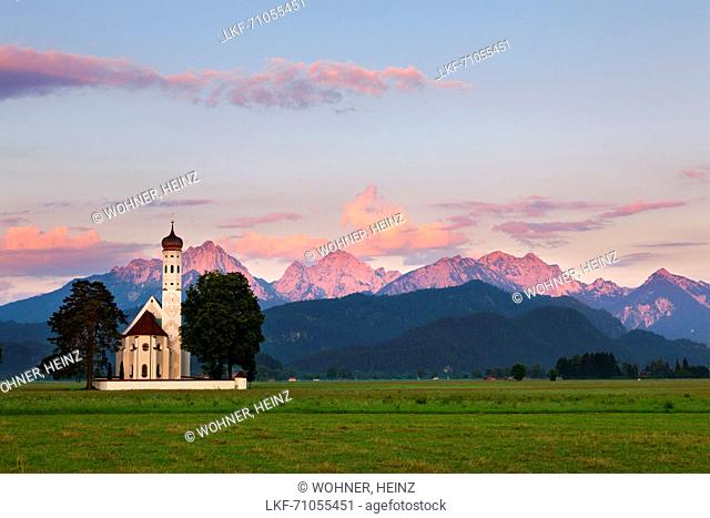 St Coloman pilgrimage church near Schwangau at dawn, view to Tannheimer Berge, Allgaeu, Bavaria, Germany