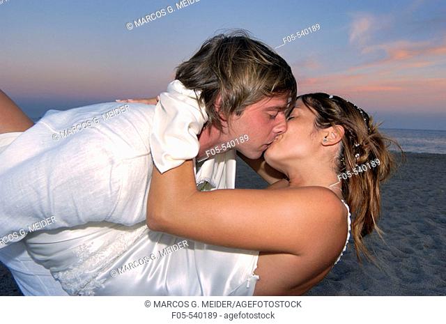 Happy young newly married couple kissing