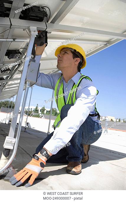 Maintenance worker adjusting solar panel in Los Angeles California