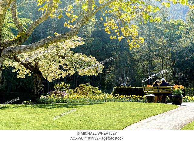 Couple on bench, Butchart Gardens, Brentwood Bay, near Victoria, British Columbia, Canada