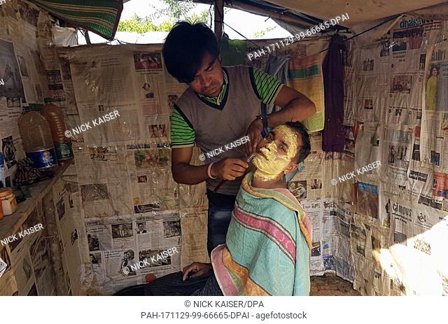 A man undergoes a shave at a hairdressing salon at the Rohingya refugee camp in Thaingkhali, Bangladesh, 28 November 2017. Photo: Nick Kaiser/dpa