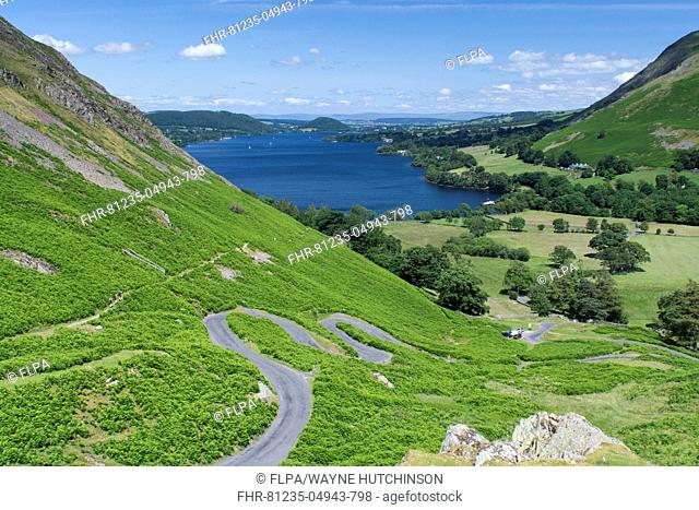 View of winding road and upland lake, Ullswater, from Martindale looking over Hallin Fell and Howtown, Lake District, Cumbria, England, July