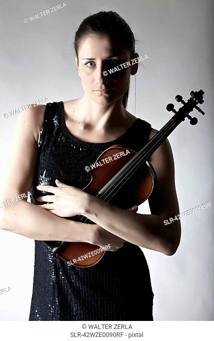 Woman in town holding violin