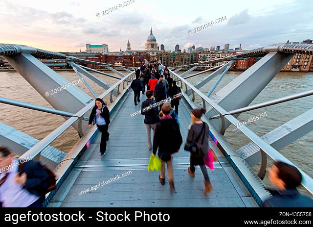 View of St. Paul's Cathedral across the pedestrian Millennium Bridge over the Thames. Shooting point higher than a man