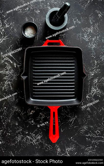 Cast iron pan on a dark background. Top view, copy space