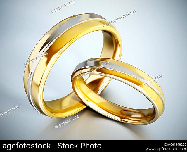 Wedding rings on white reflective surface