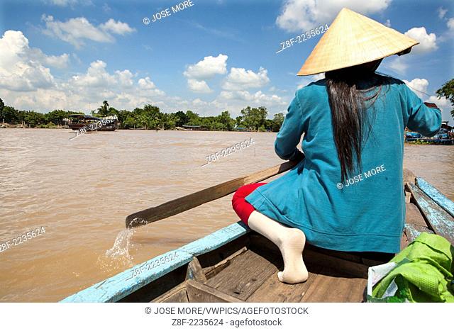 Traditional boats carry freight on the Mekong River and canals near Ben Tre