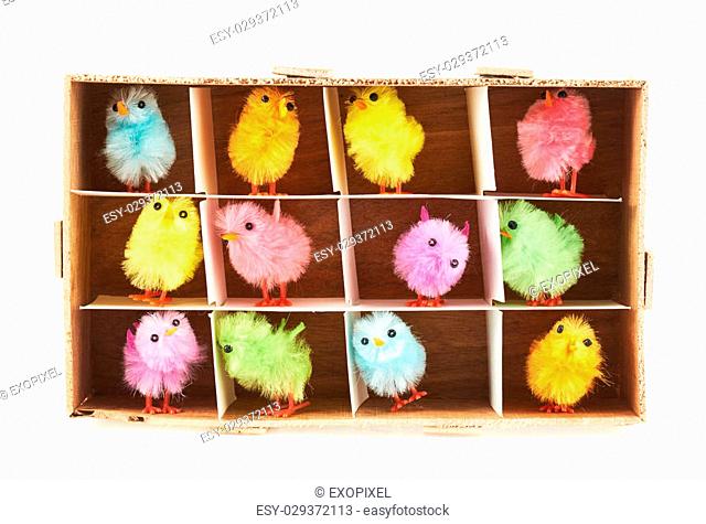 Toy chickens in wooden box isolated over the white background