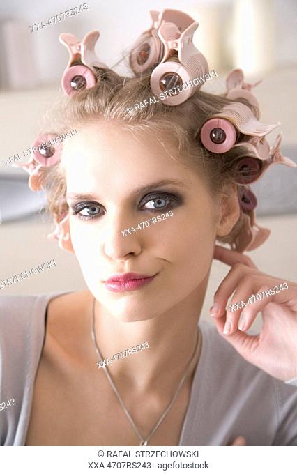 young woman with curler on hair