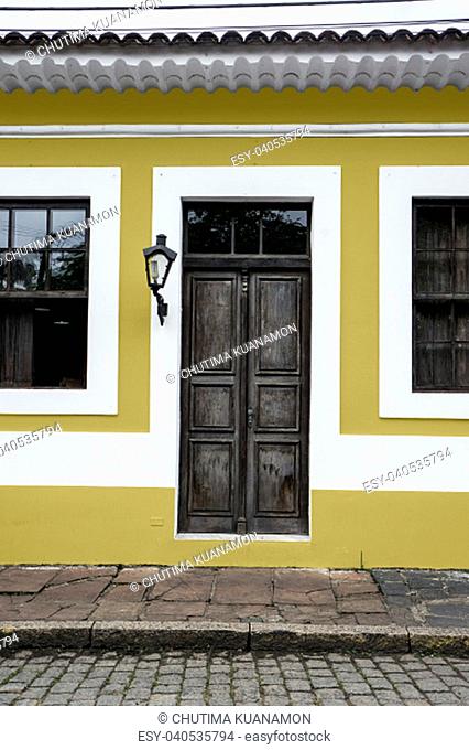 city Morretes Brazil old light chandelier design wooden door glass windows yellow wall