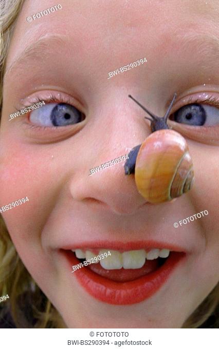 little girl with snake on her nose