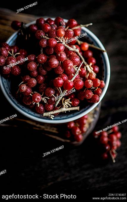 Organic food concept with bowl full of shepherdia or bullberries on wooden background with copy space