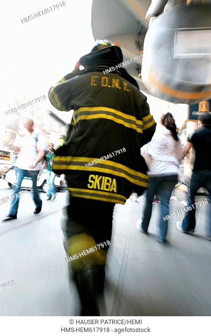United States, New York City, Manhattan, fireman walking on the pavement